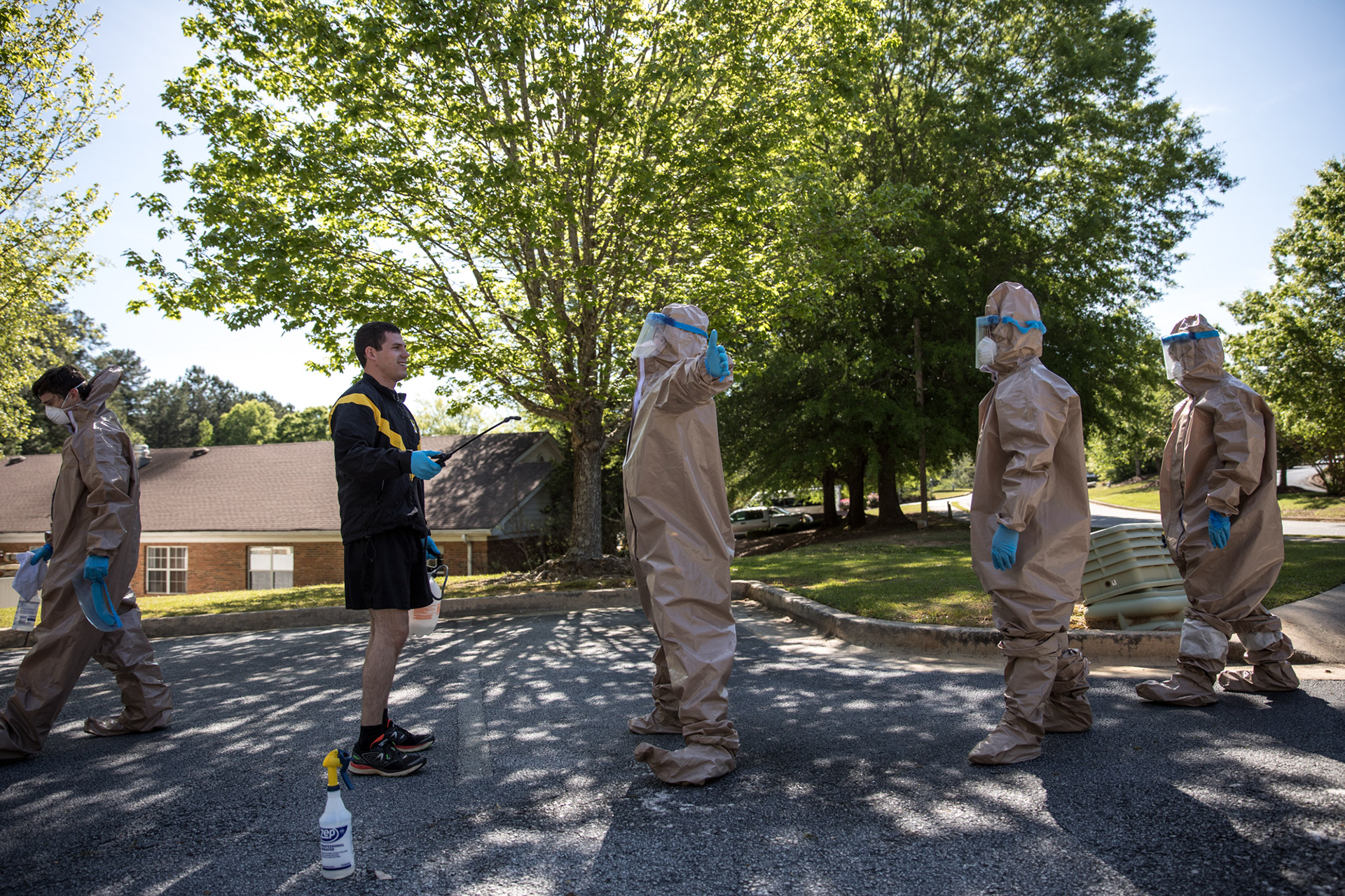 Georgia National Guardsmen wear full infection control gear and wield disinfecting spray as they clean the Condor Health Lafayette nursing home in Fayetteville on April 22.