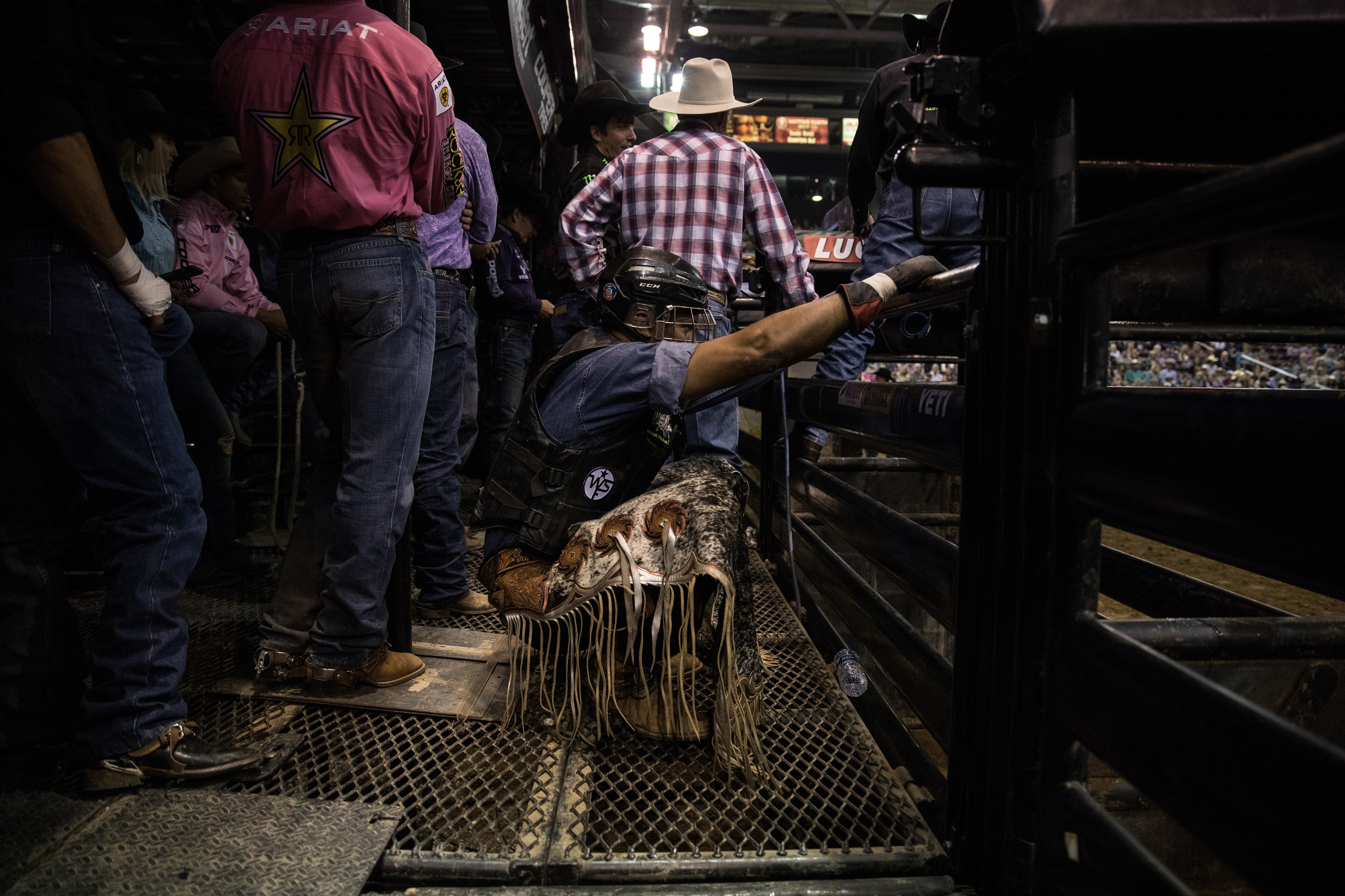 A bull rider stretches before it's his turn to go during the Professional Bull Riders show at the Ford Idaho Center in Nampa on Oct. 20.