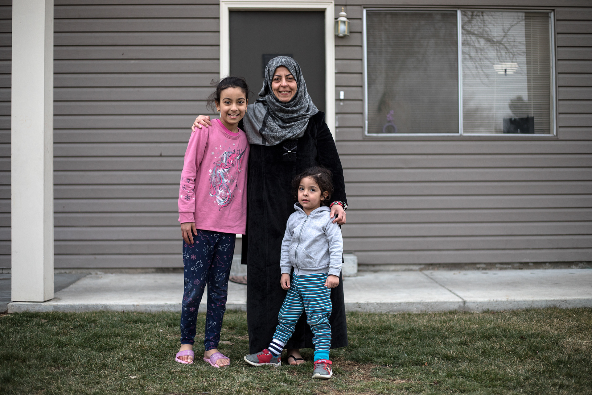 Wejdan Khudhair stands with her son Mustafa, 3, and daughter Om Albanin, 8, outside of their apartment on Feb. 8 in Boise.