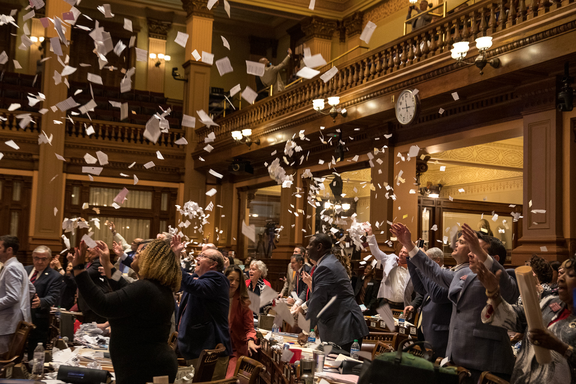 Georgia House lawmakers toss paper into the air, a tradition on the Sine Die, the last day of the 2022 legislative session.