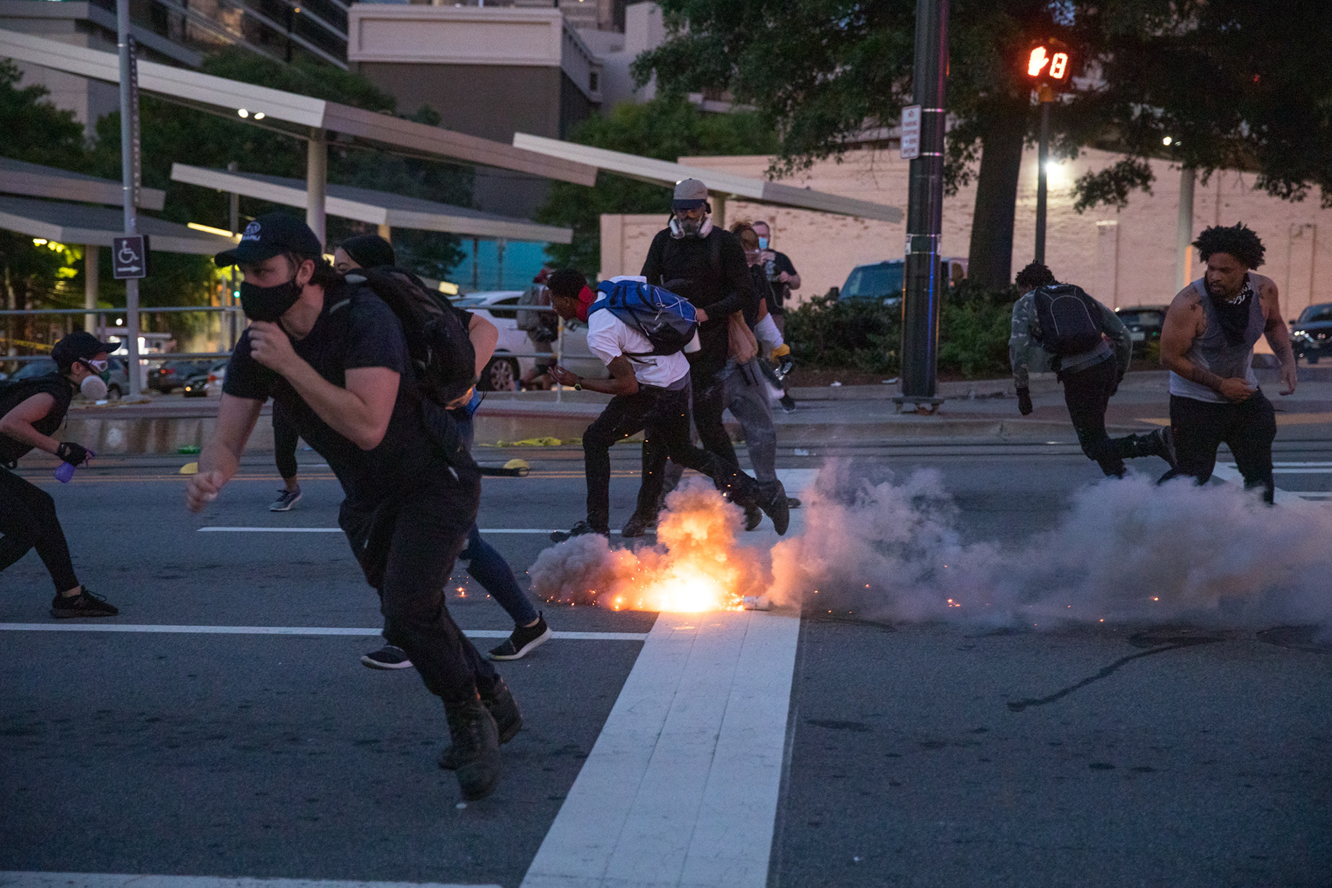 Protesters run from a small explosive during the third day of protests in downtown Atlanta on May 31.