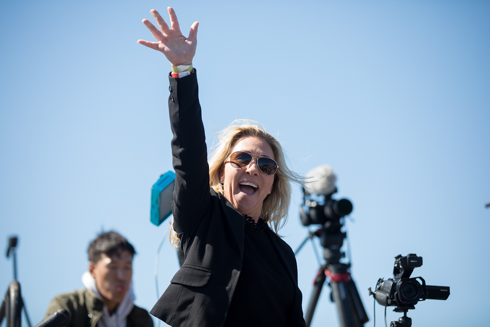 U.S. Rep. Marjorie Taylor Greene gestures to the crowd at a Donald Trump rally in Dalton, Ga.