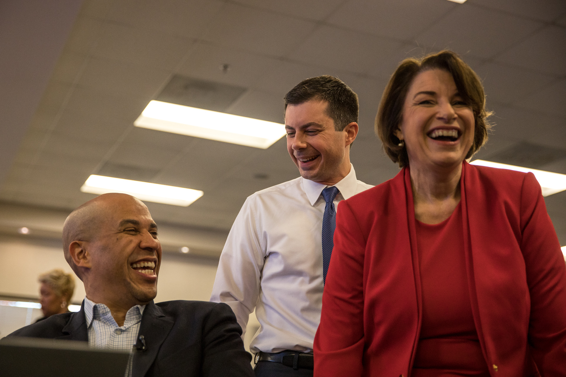 Democratic presidential candidates Cory Booker, Pete Buttigieg and Amy Klobuchar share laughs at the FairFight phone bank event at the Ebenezer Baptist Church in Atlanta on Nov. 21.