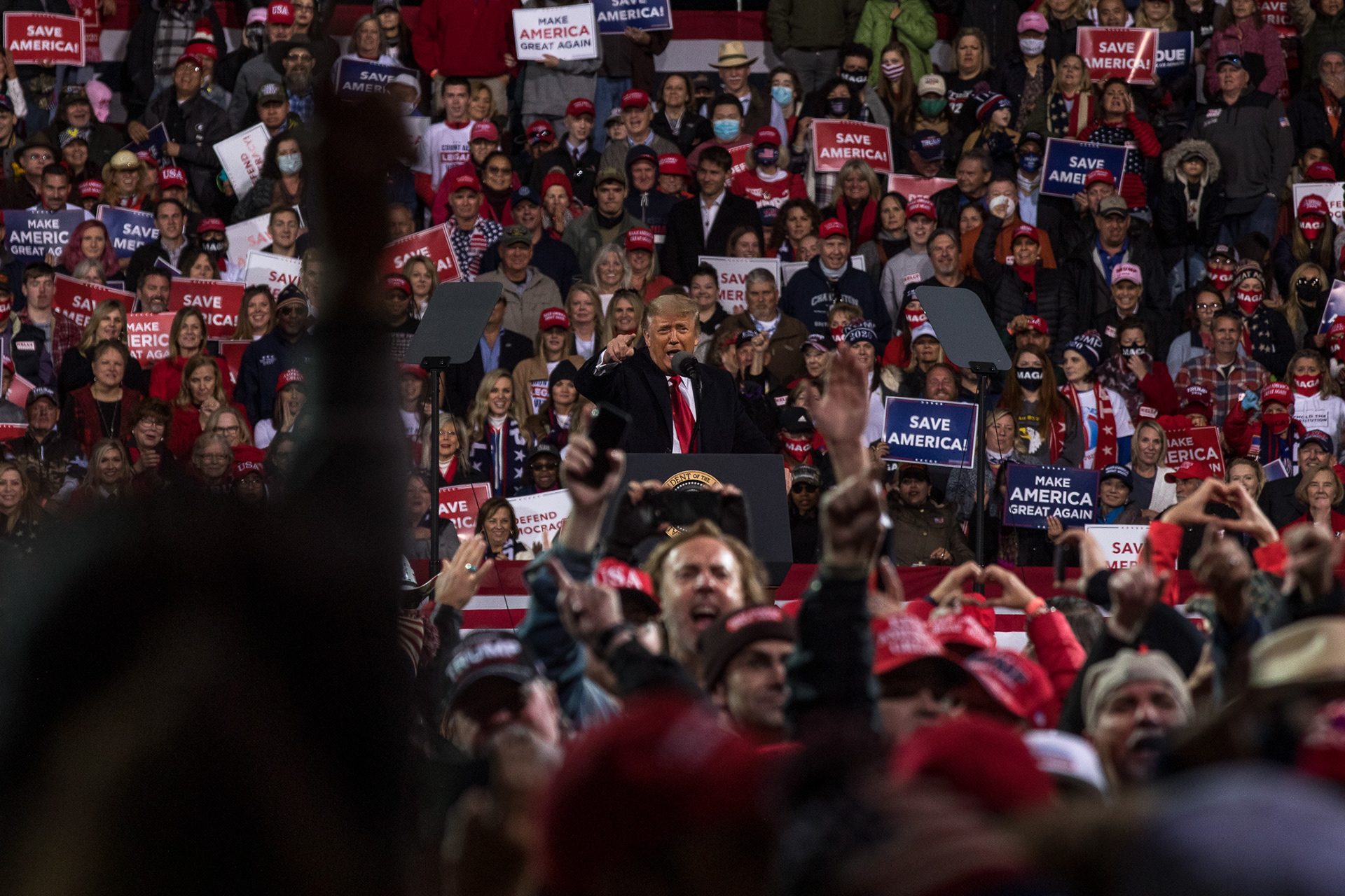 President Donald Trump points and yells at the press in the back of a rally in Valdosta.