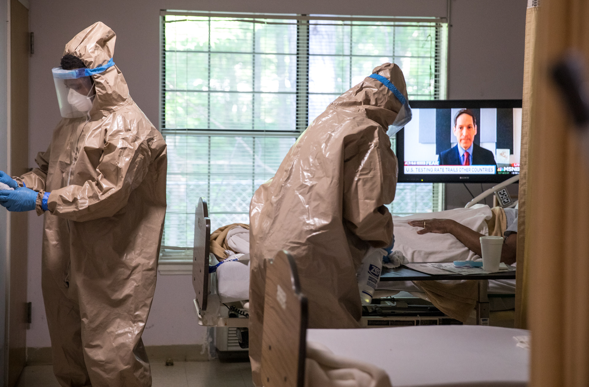 Georgia National Guardsmen wear full infection control gear and wield disinfecting spray as they clean the Condor Health Lafayette nursing home in Fayetteville on April 22.