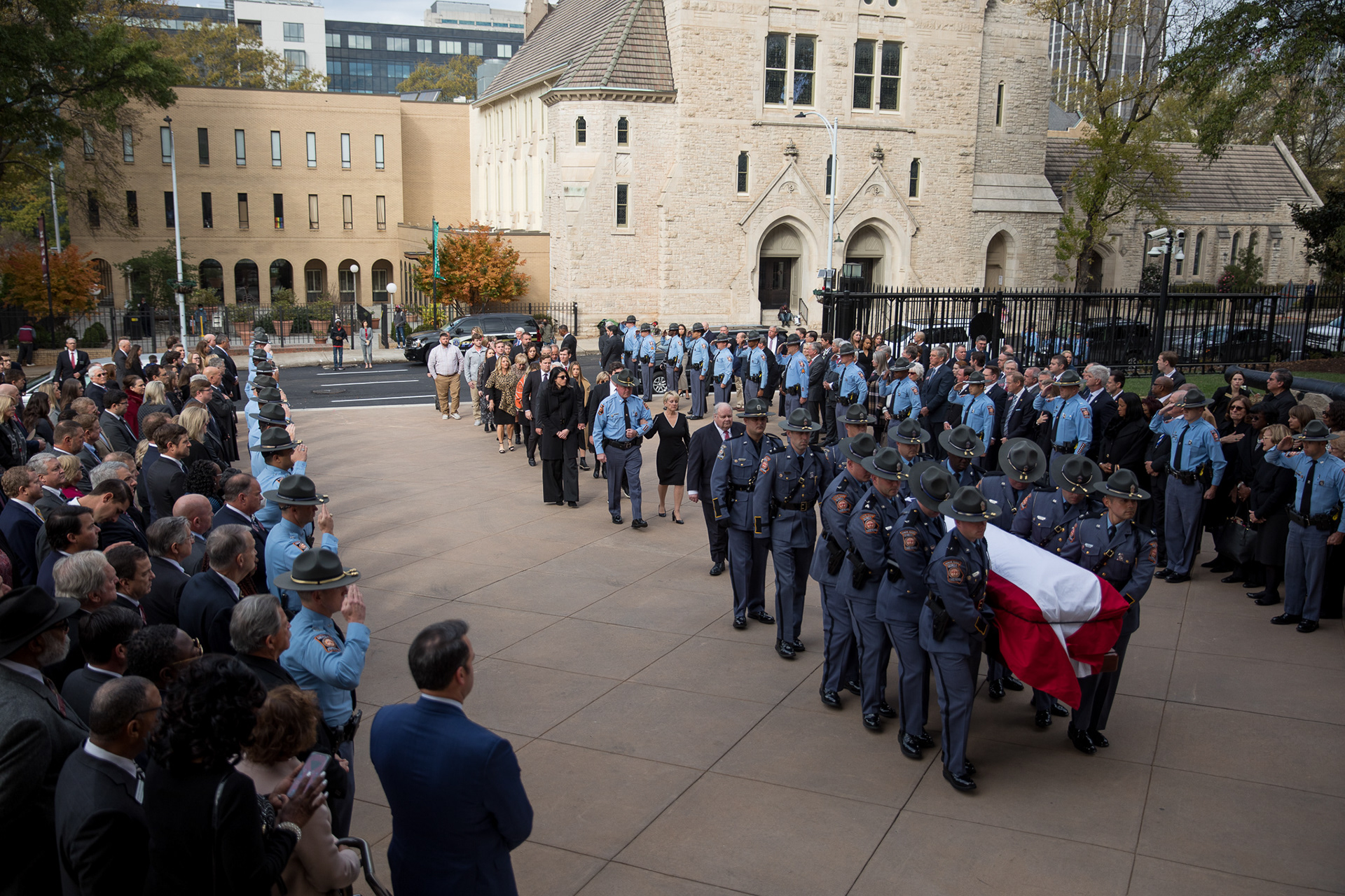 Georgia State Patrol officers carry the casket of David Ralston, former speaker of the Georgia House, into the state capitol building.