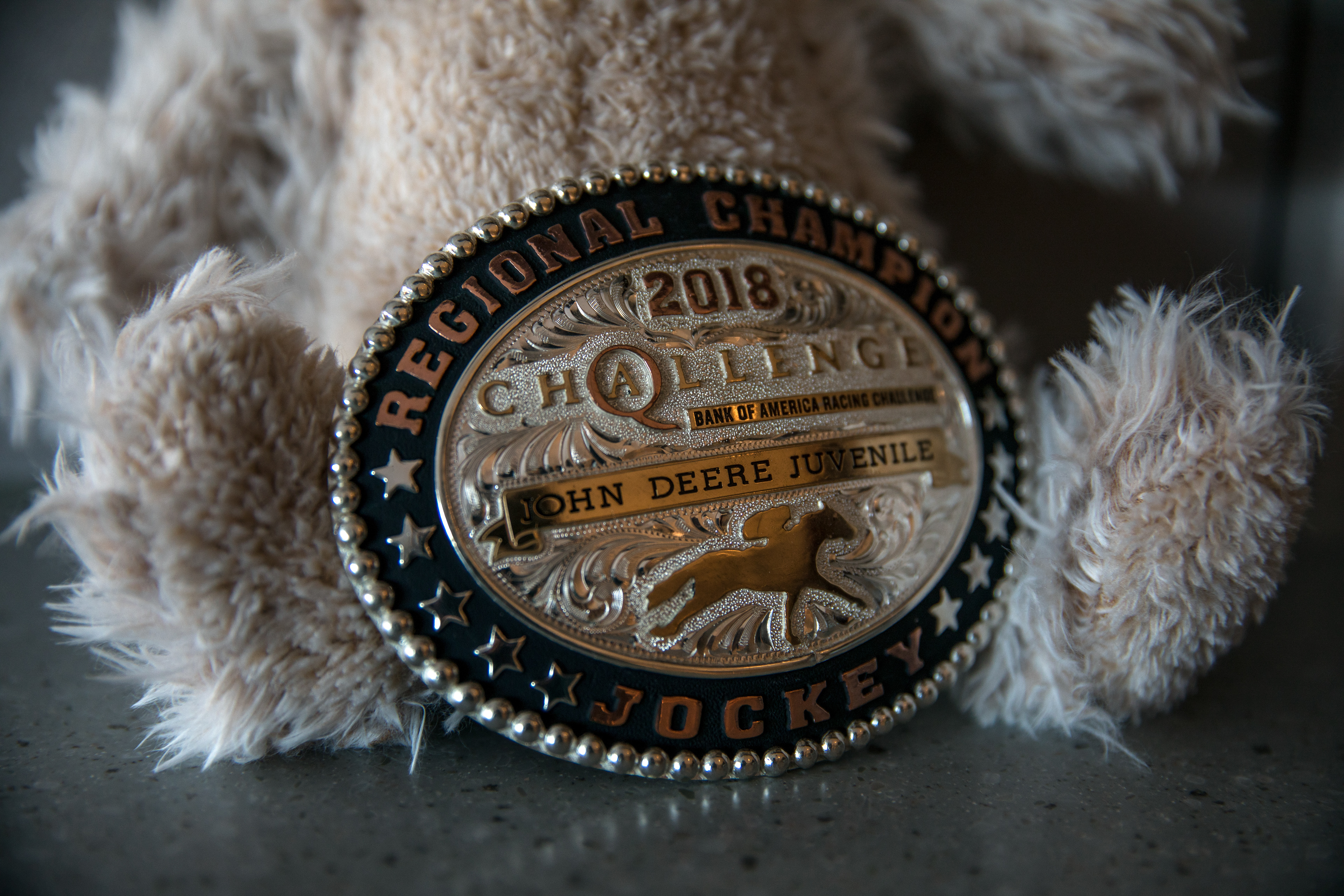 One of the last belt buckles Nikeela Black won sits against a teddy bear in her room at Craig Hospital in Englewood, Colo., on Oct. 17.