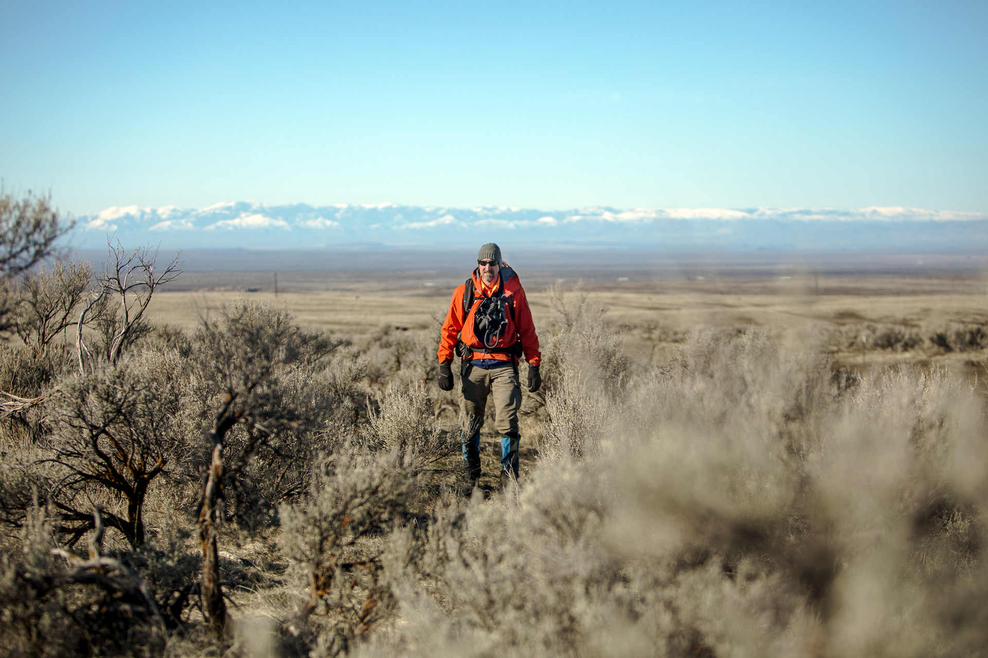 Gregg Rettschalg, decade-long member and current president sweeps a search area with other members during a field training on March 16 at Bonneville Point just outside of Boise.