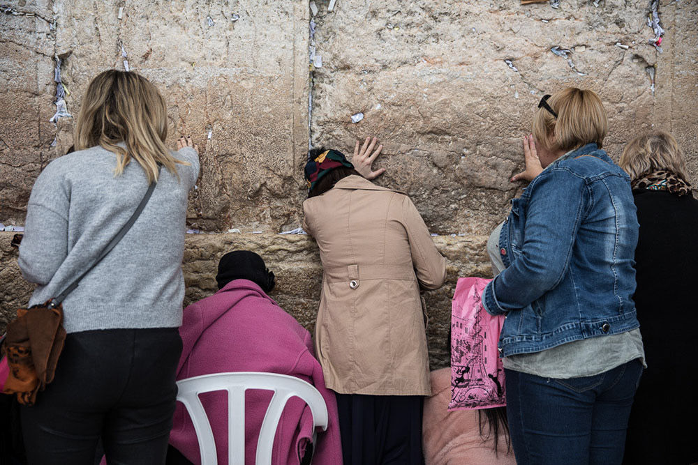 Eyes closed, hundreds of women bow their heads and sway back and forth as they pray at the Western Wall, a piece of limestone that sits 62 feet tall outside of the Temple Mount. Not allowed within the Temple Mount, the Wall outside is the holiest site in the Jewish faith to pray.