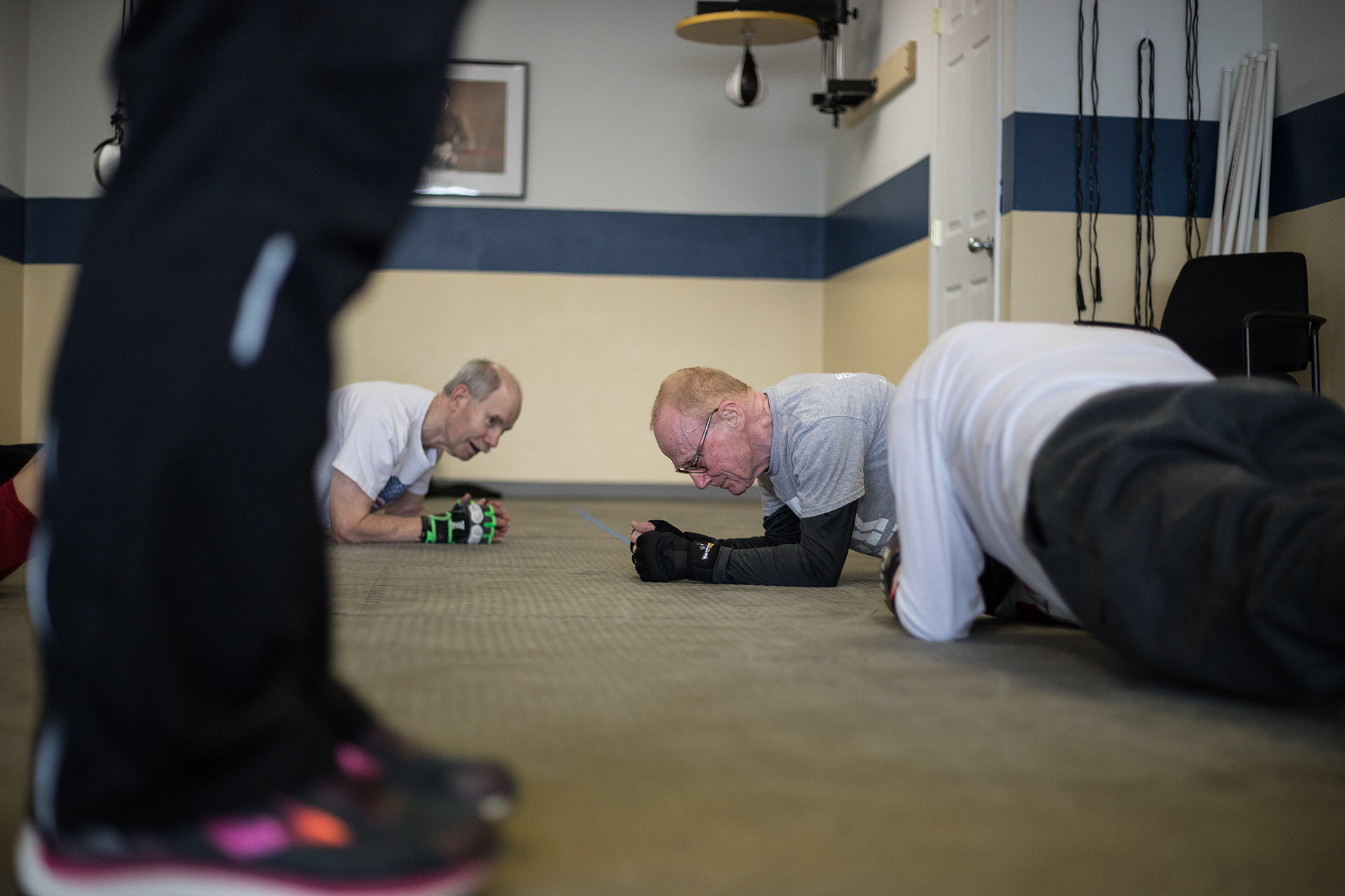 Rock Steady Boxing class members run through exercises while Coach Jeanette Riley keeps time.