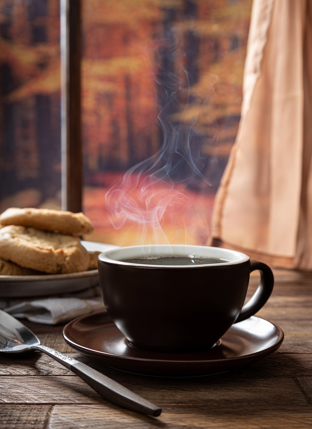 Hot cup of coffee with autumn background