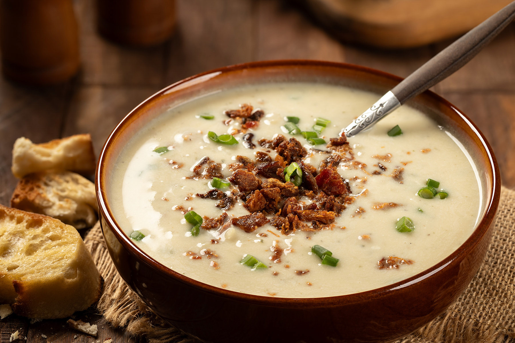 Creamy potato soup with bacon bits and grreen onion