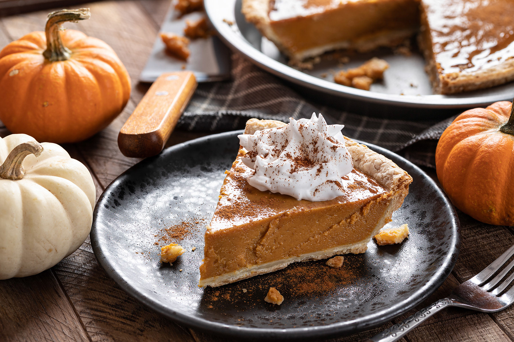 Slice of pumpkin pie with whipped cream
