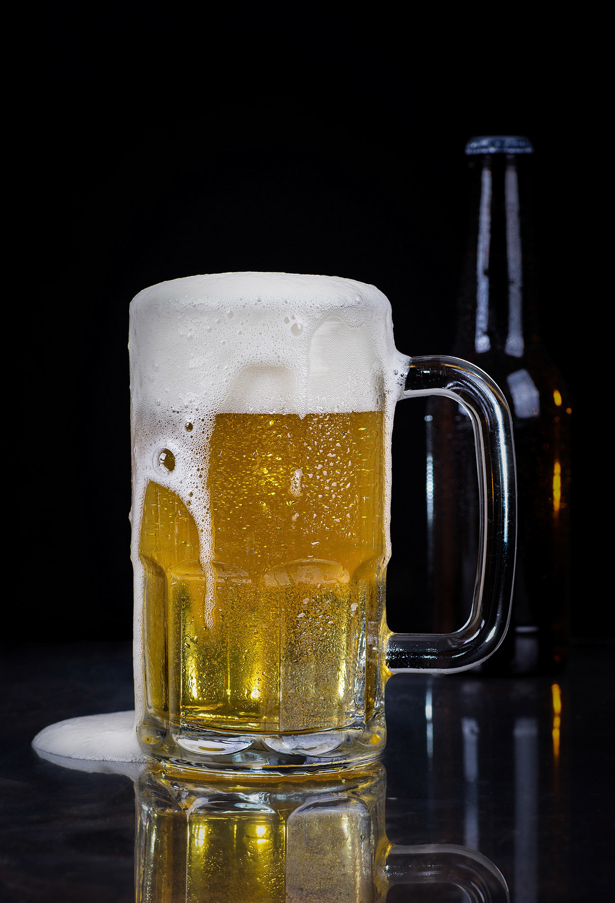 Glass of cold beer on a blsck background