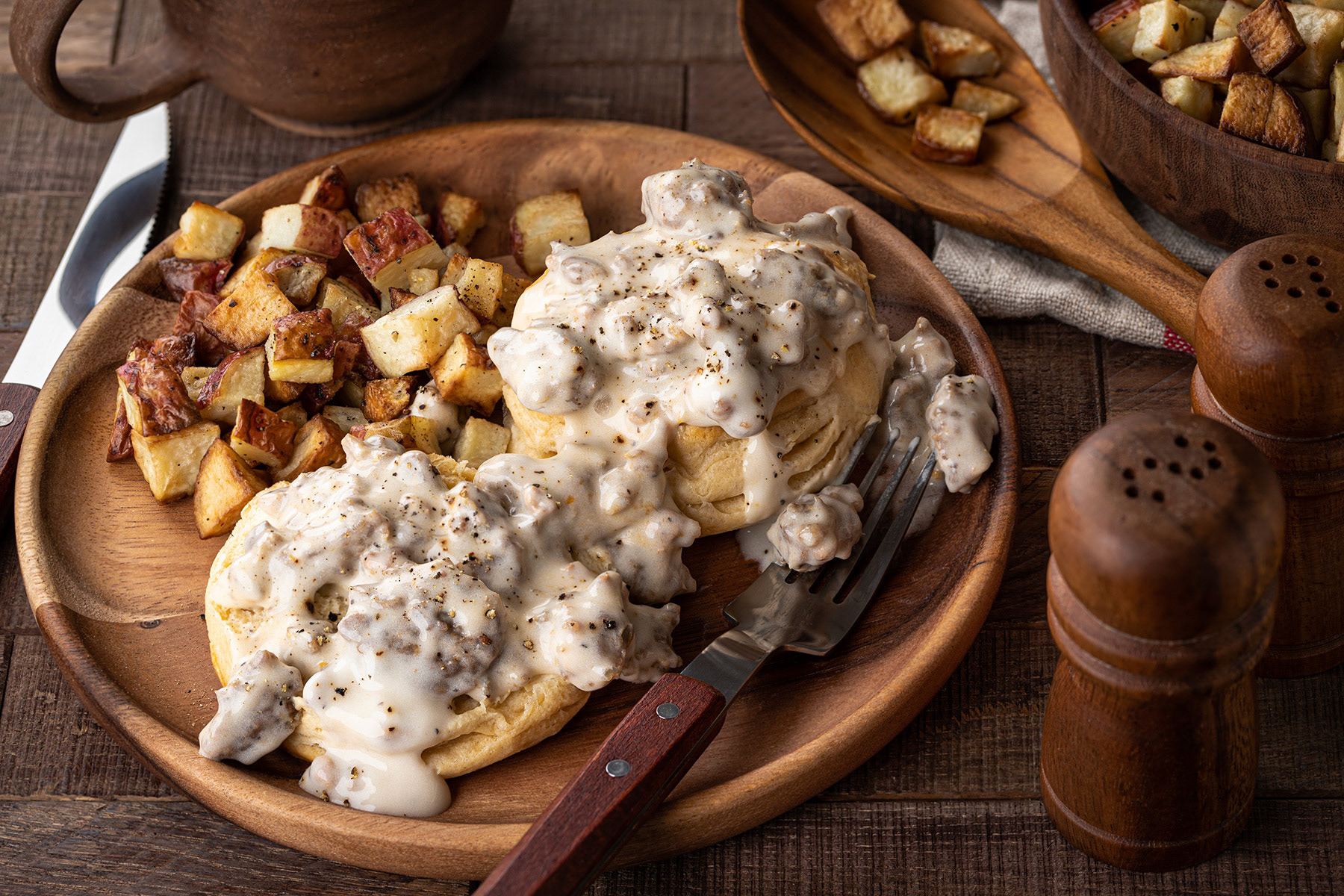 Biscuits with sausage gravy and fried potatoes