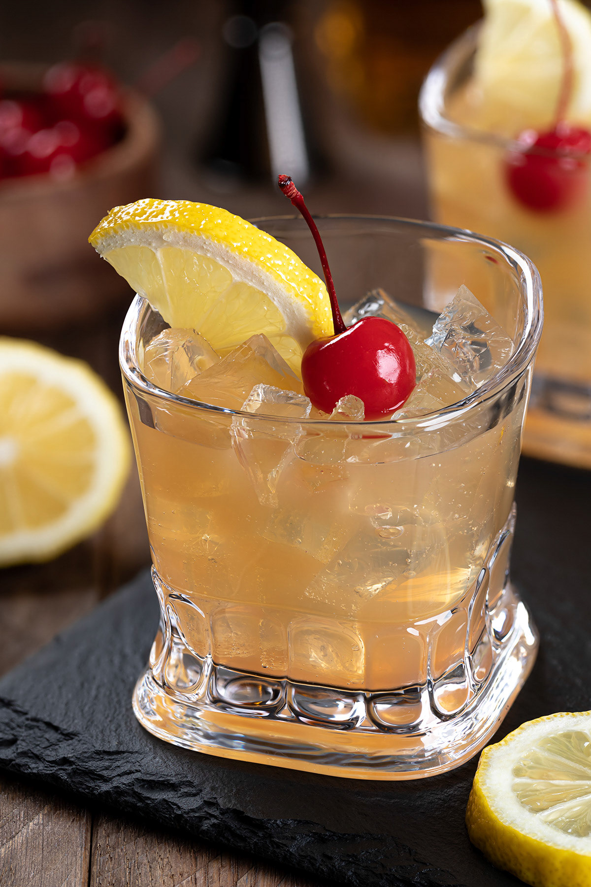 Whiskey sour with cherry and lemon slice