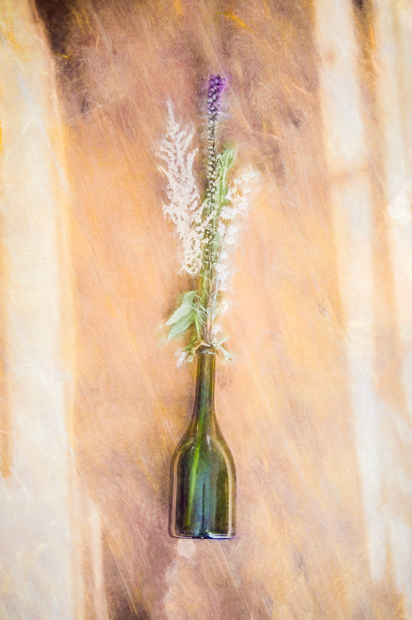Flowers in a green bottle