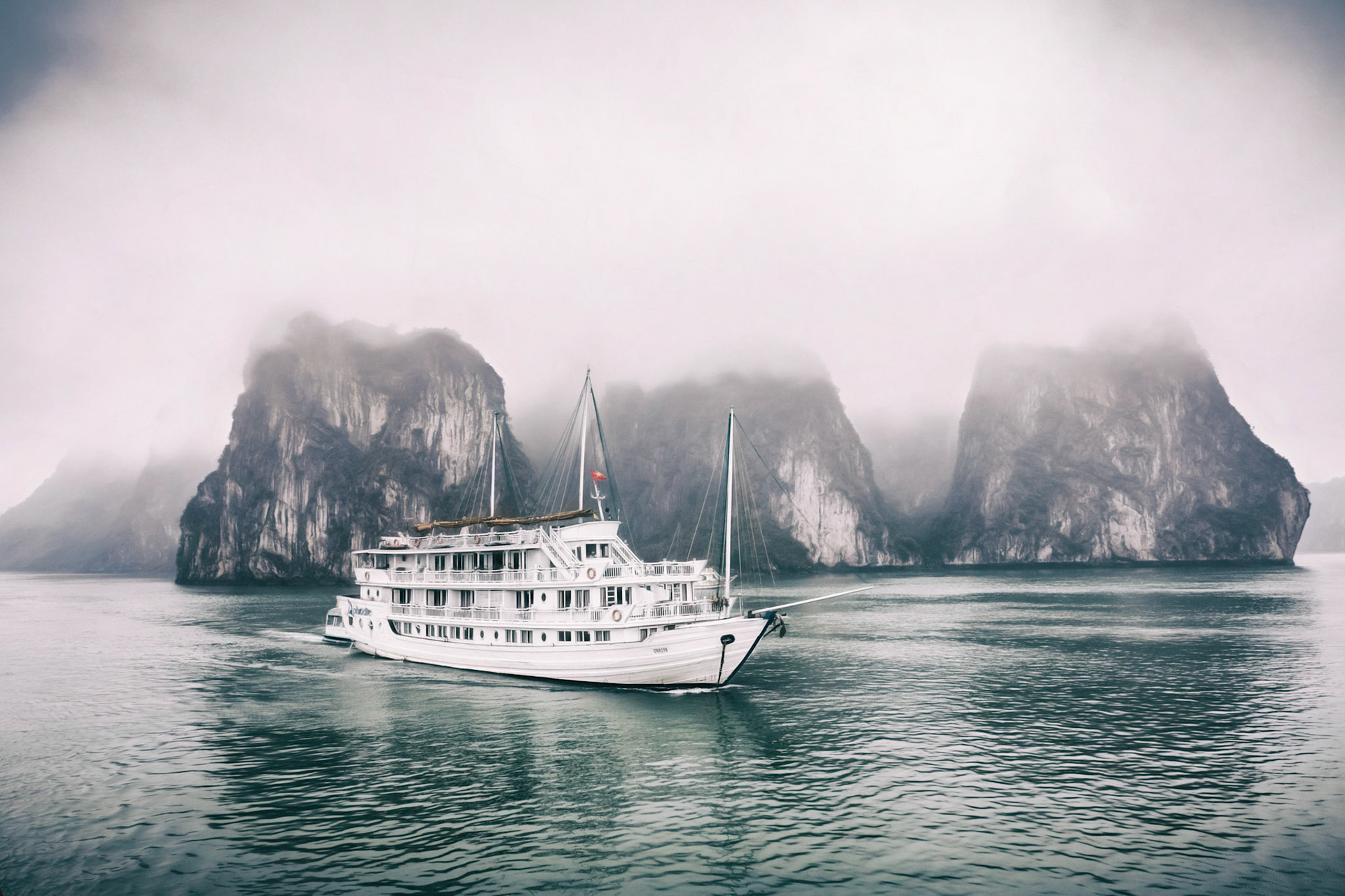 Cruise boats on a misty day at Halong Bay, Vietnam, South East Asia