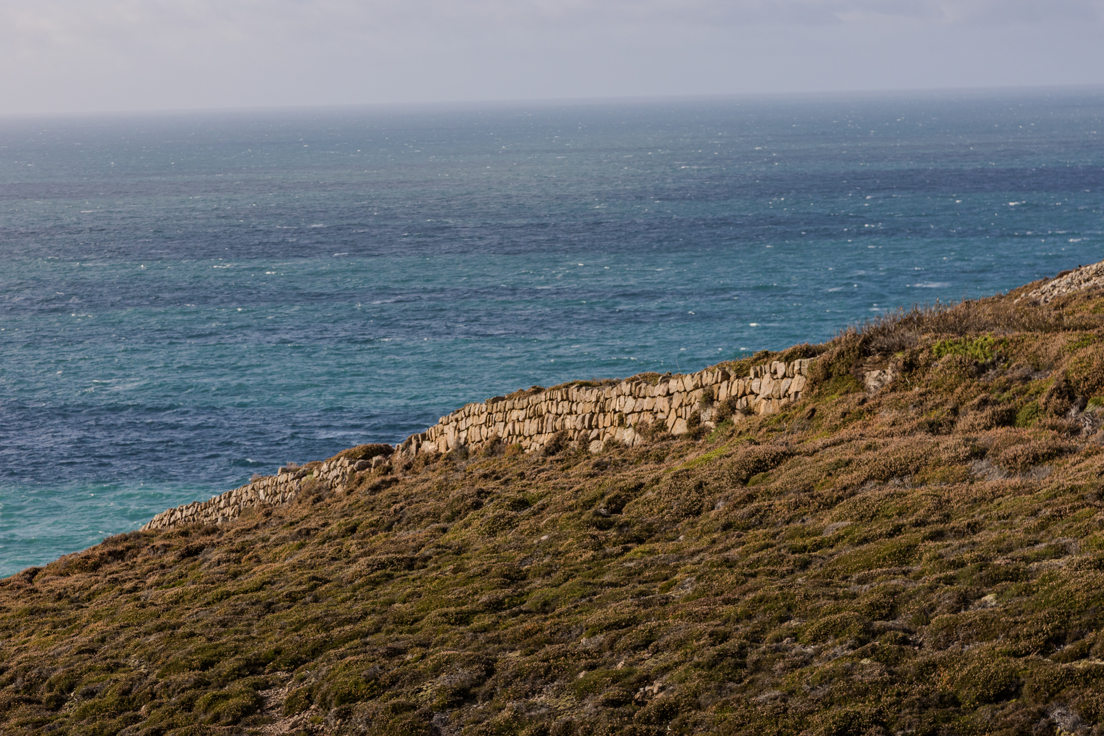 Abstract photo of a wall against the sea background.
