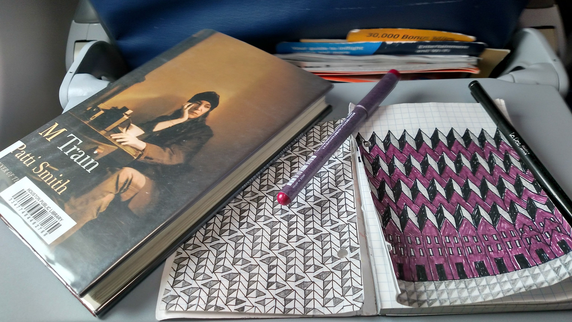 READING AND DOODLING ON A SMOOTH FLIGHT