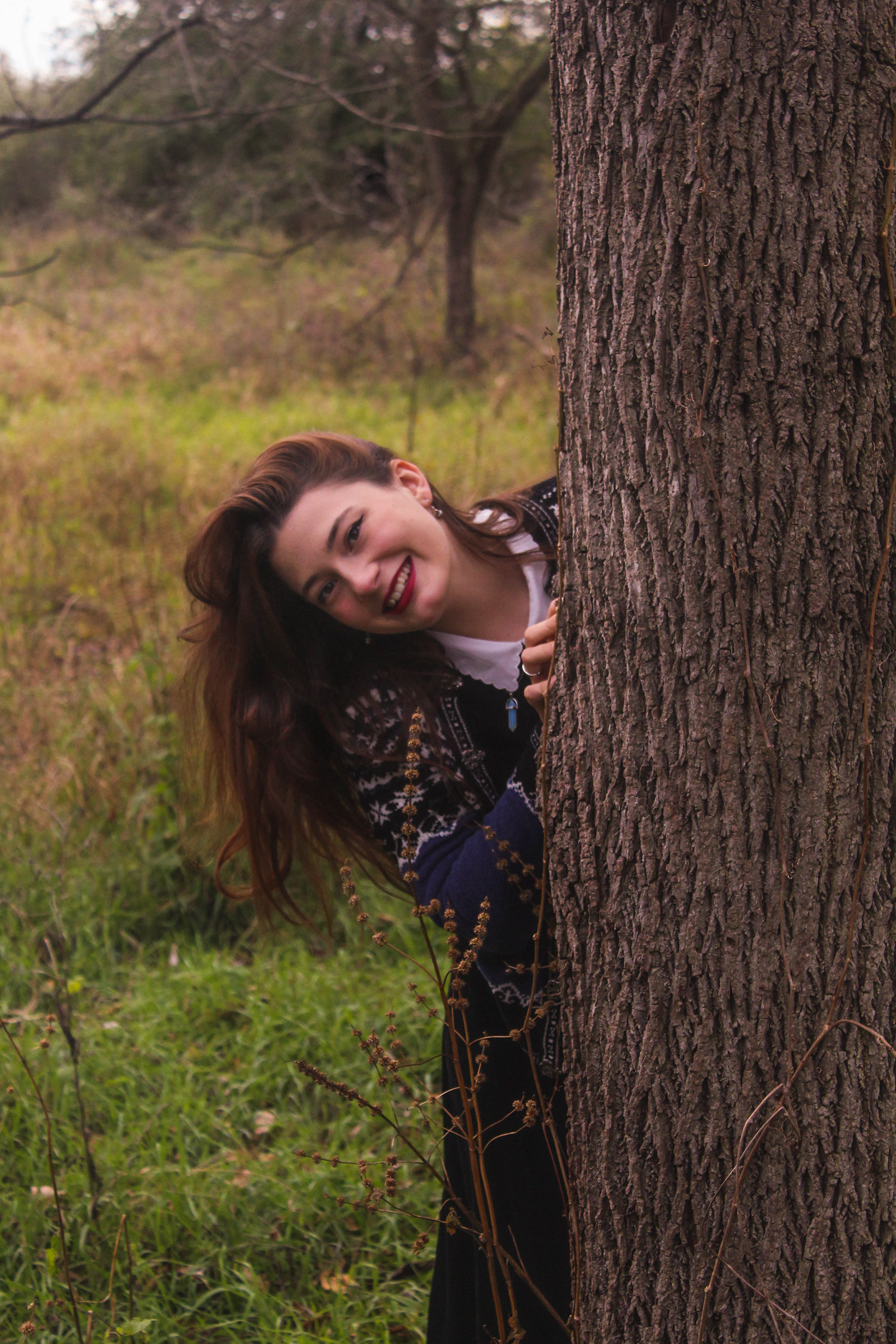 October 2020 | Portrait of Sophia leaning out from behind a tree
