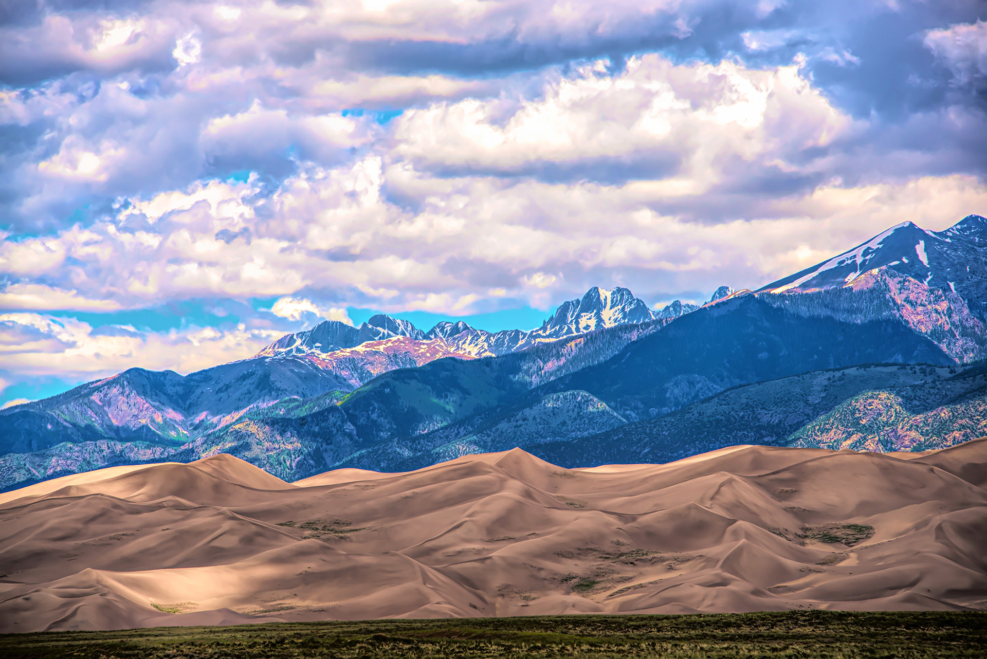 Sand dunes mountains and sky