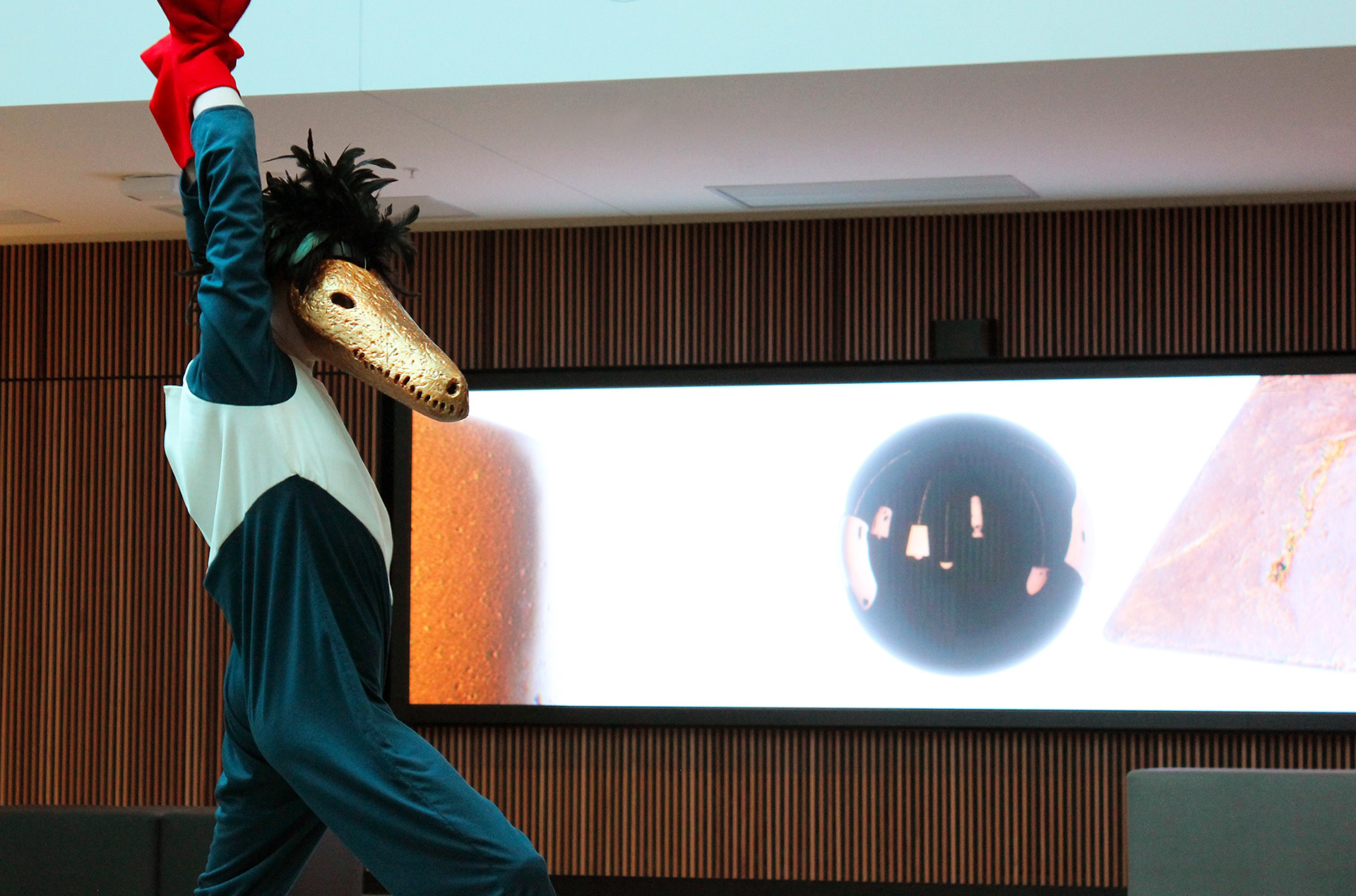 (2022). Lada in front of the display screen, The Mirror Sphere. [Photograph]. Taken by Author.