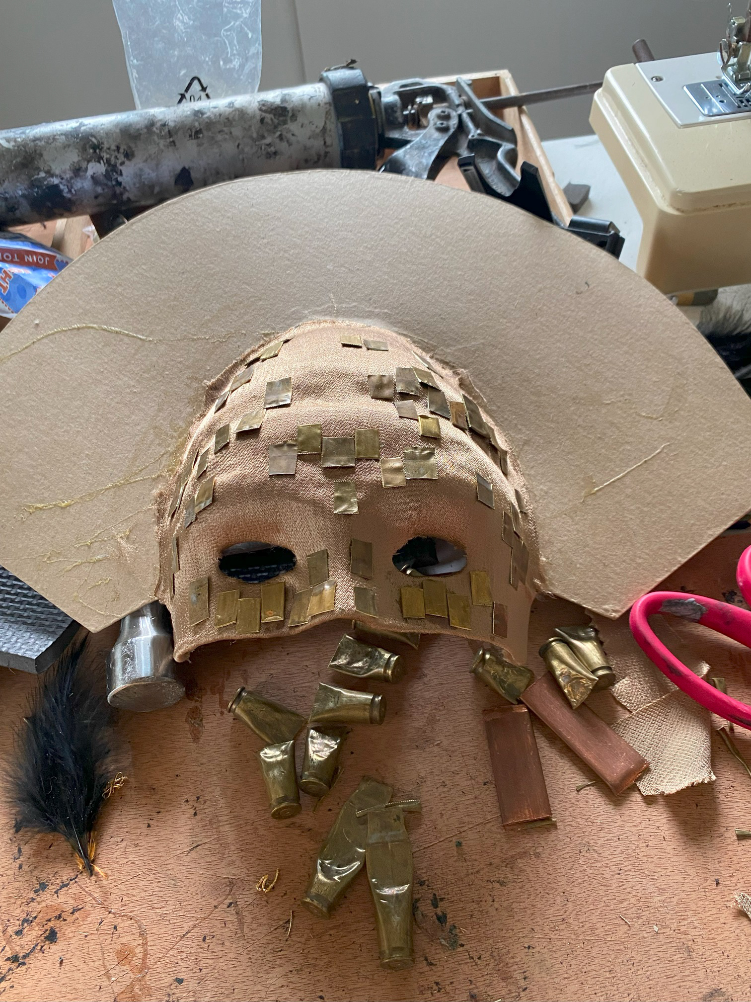 (2022). Attaching more brass to Nero's mask. [Photograph].