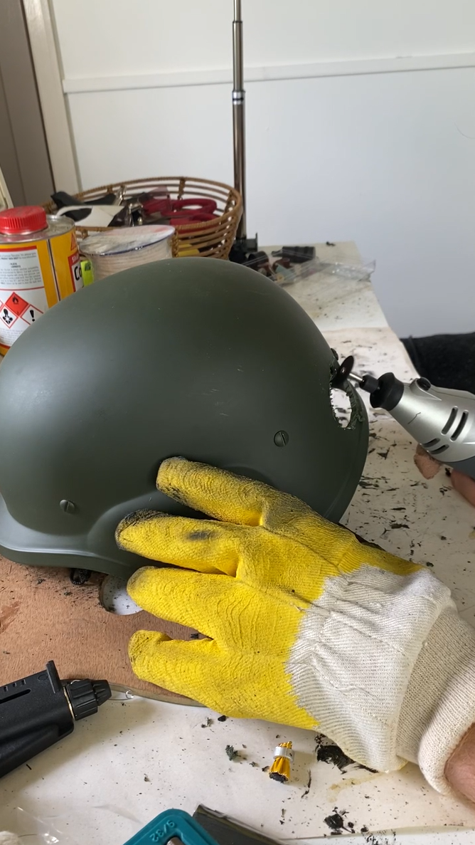 (2022). Carving into helmet to make the Technician's Mask. [Photograph].