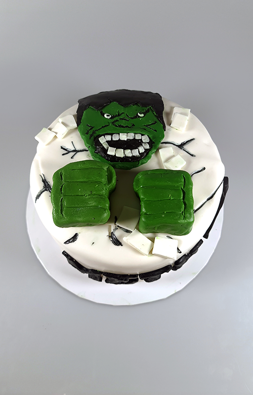 Cake covered with fondant and Hulk's face and hands also made out of fondant