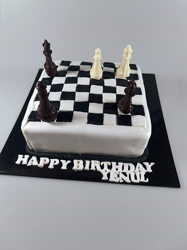 Fondant coated vanilla cake with chess pieces made out of White & Dark Chocolate