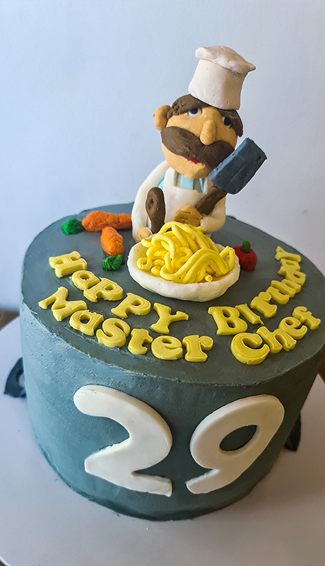 Dark blue themed vanilla cake with butter cream frosting and decorations made out of fondant
