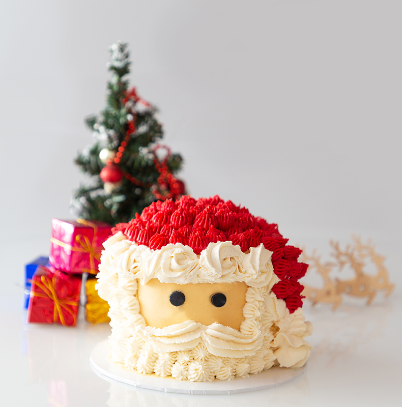 Santa themed vanilla cake covered with butter cream