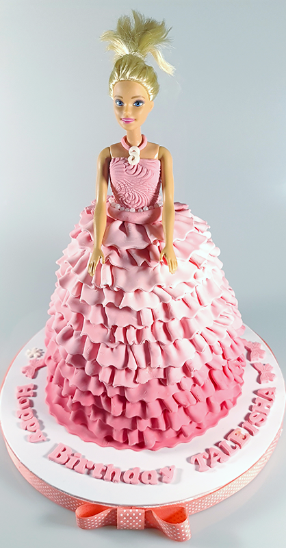 Vanilla ribbon cake with the doll dress made out of fondant