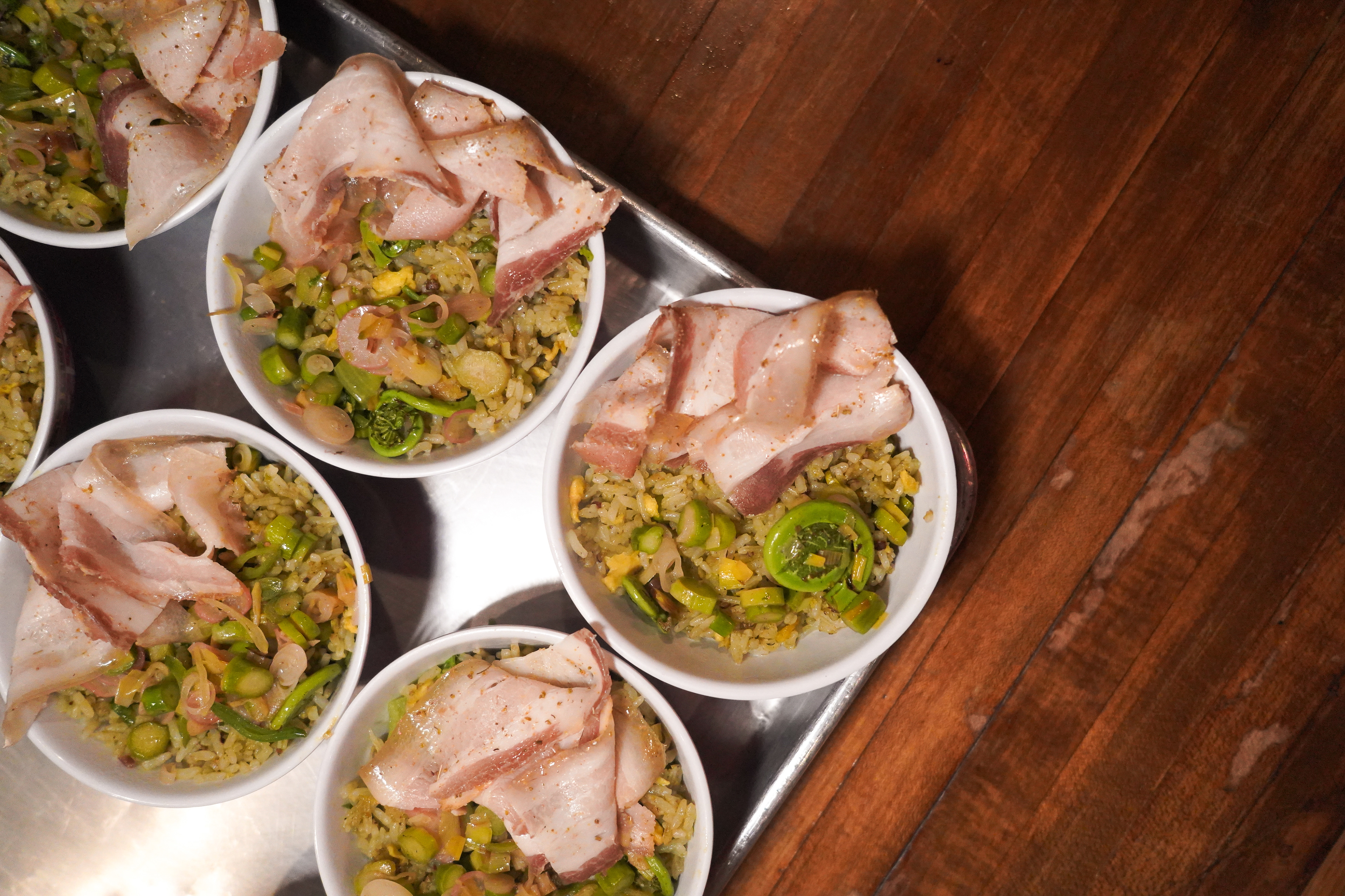 Dry-aged pork belly atop spring vegetable fried rice