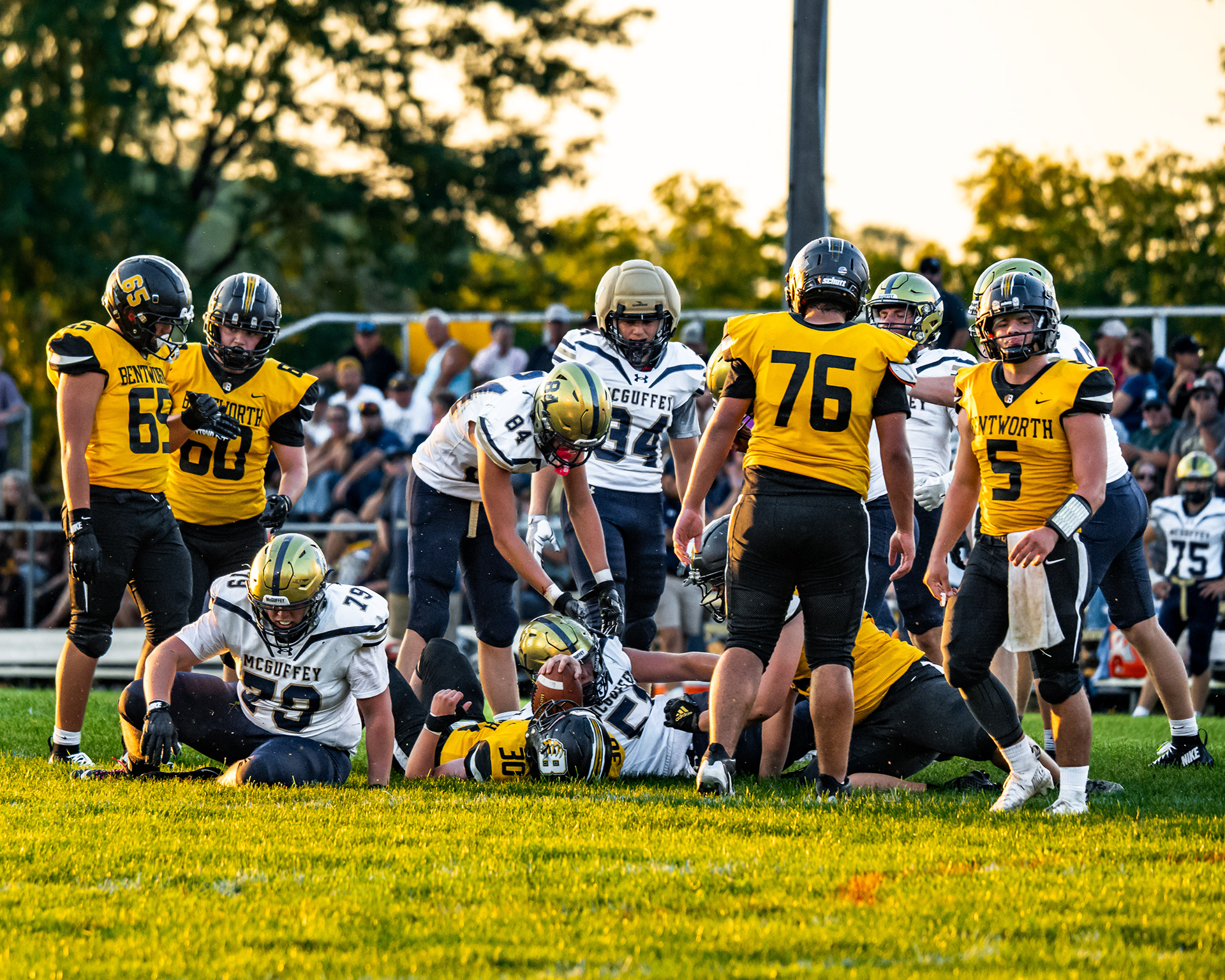 Bentworth and McGuffey players gather around a pile following a tackle during a game Friday, Aug. 28, 2026, at Ellsworth Athletic Field in Bentleyville, Pa.