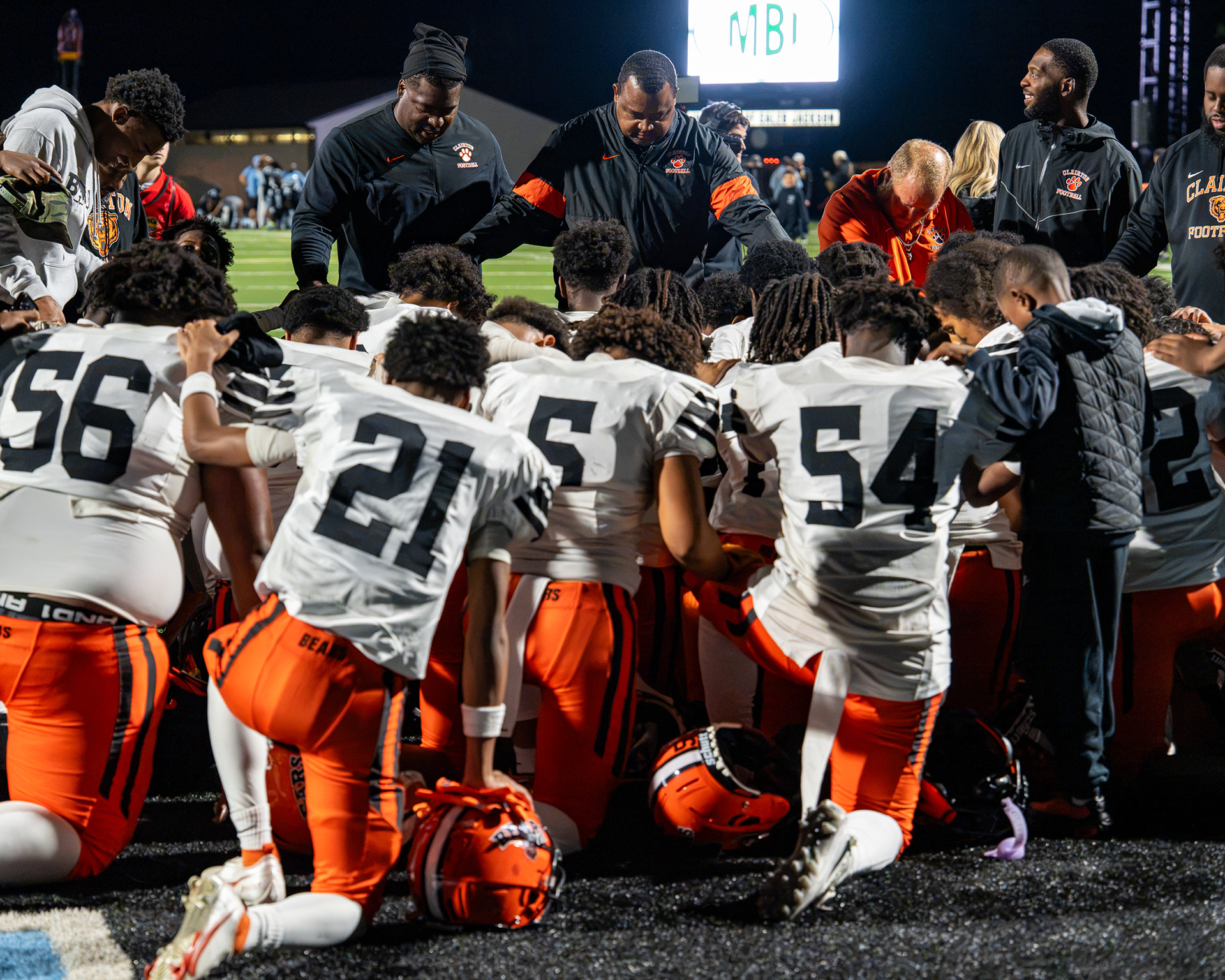 The Clairton head coach Wayne Wade Jr. leads his team in prayer after their victory over Wash high at Washington high school stadium on Sept. 25 2026