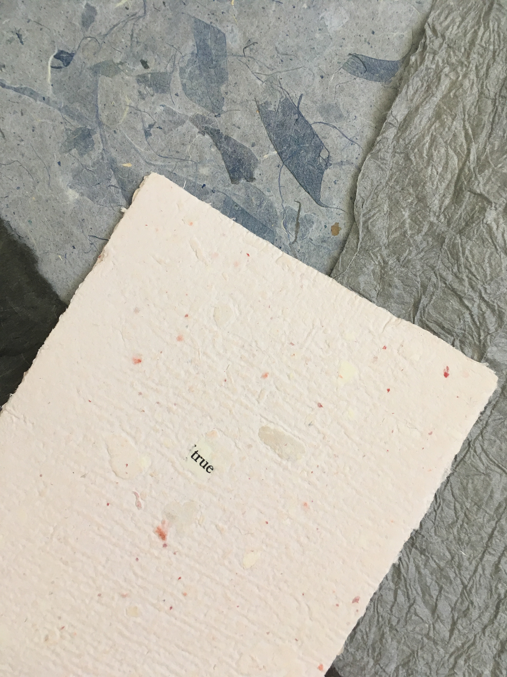 Handmade paper featuring collaged text