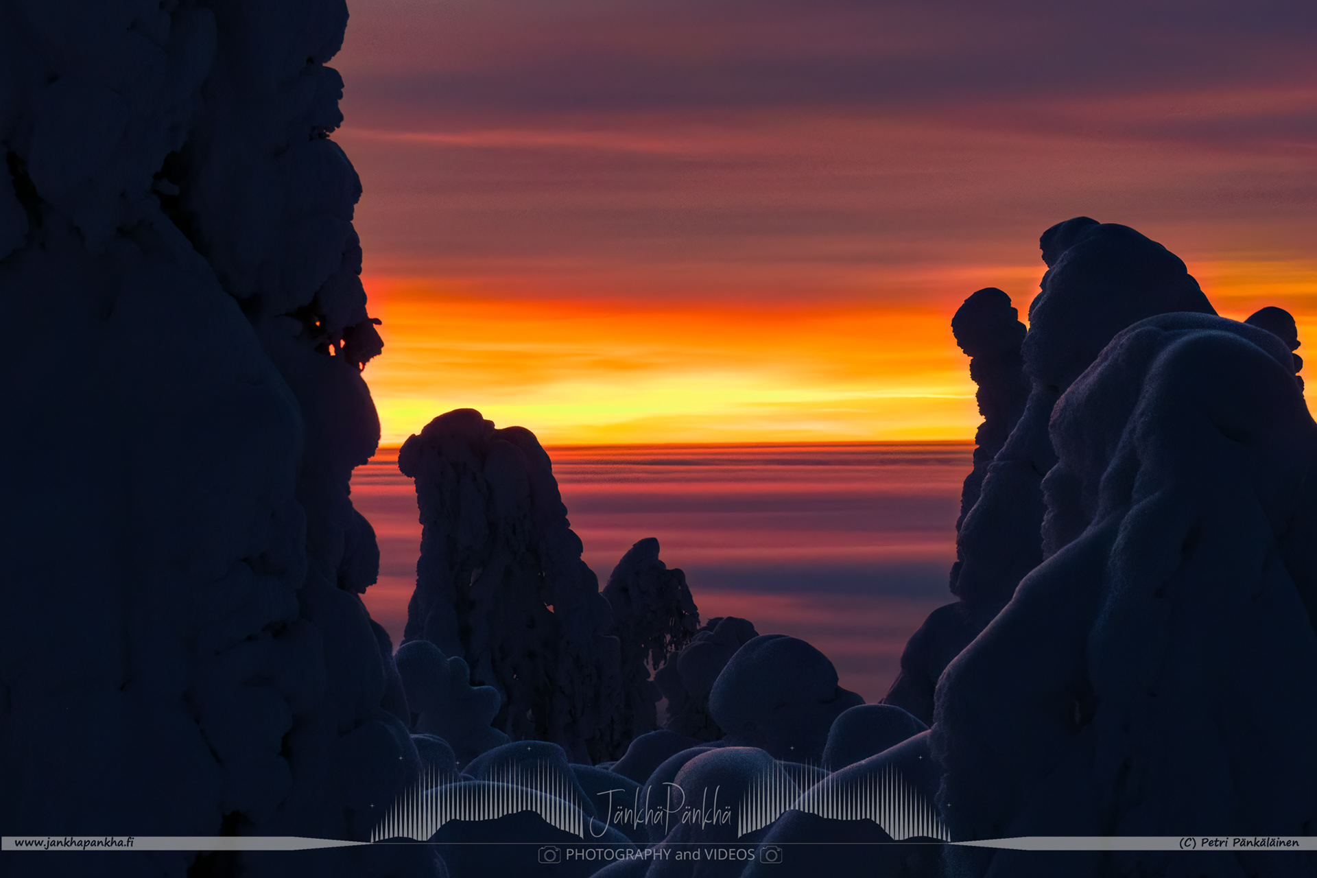Intense colors of the polar night sunset and the valley covered with clouds in Muonio, Finland