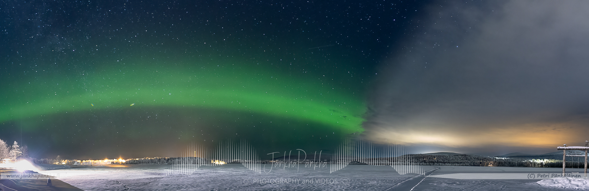 The worst moment for northern lights photographer. The cloud coverage approaching and and soon preventing the photoshooting. Aurora borealis arc and Äkäslompolo village lights.