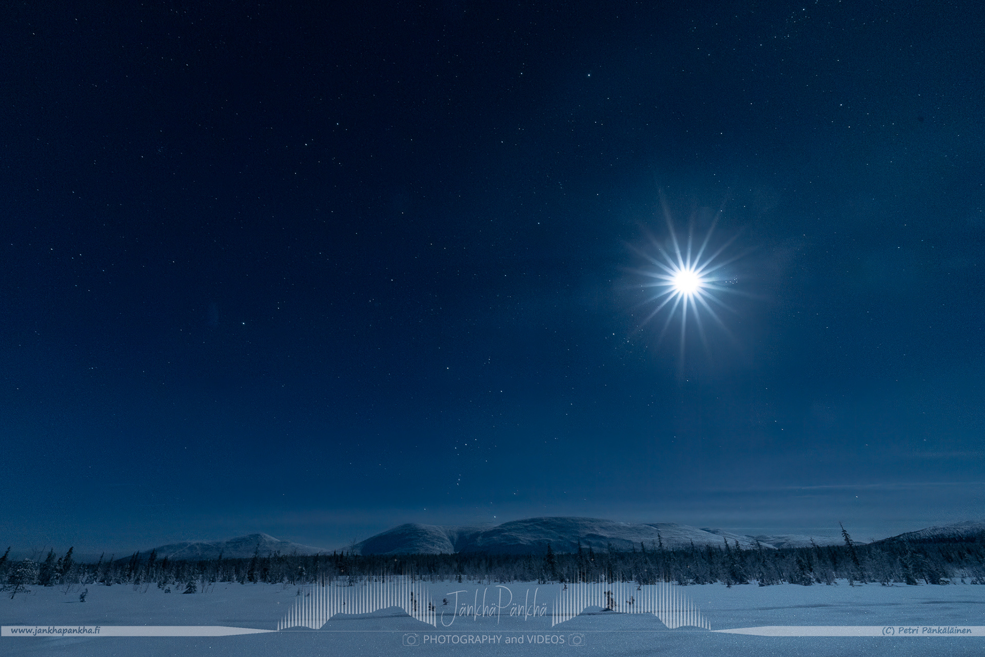 A bright moon over the Pallastunturi fell in Lapland, Finland.