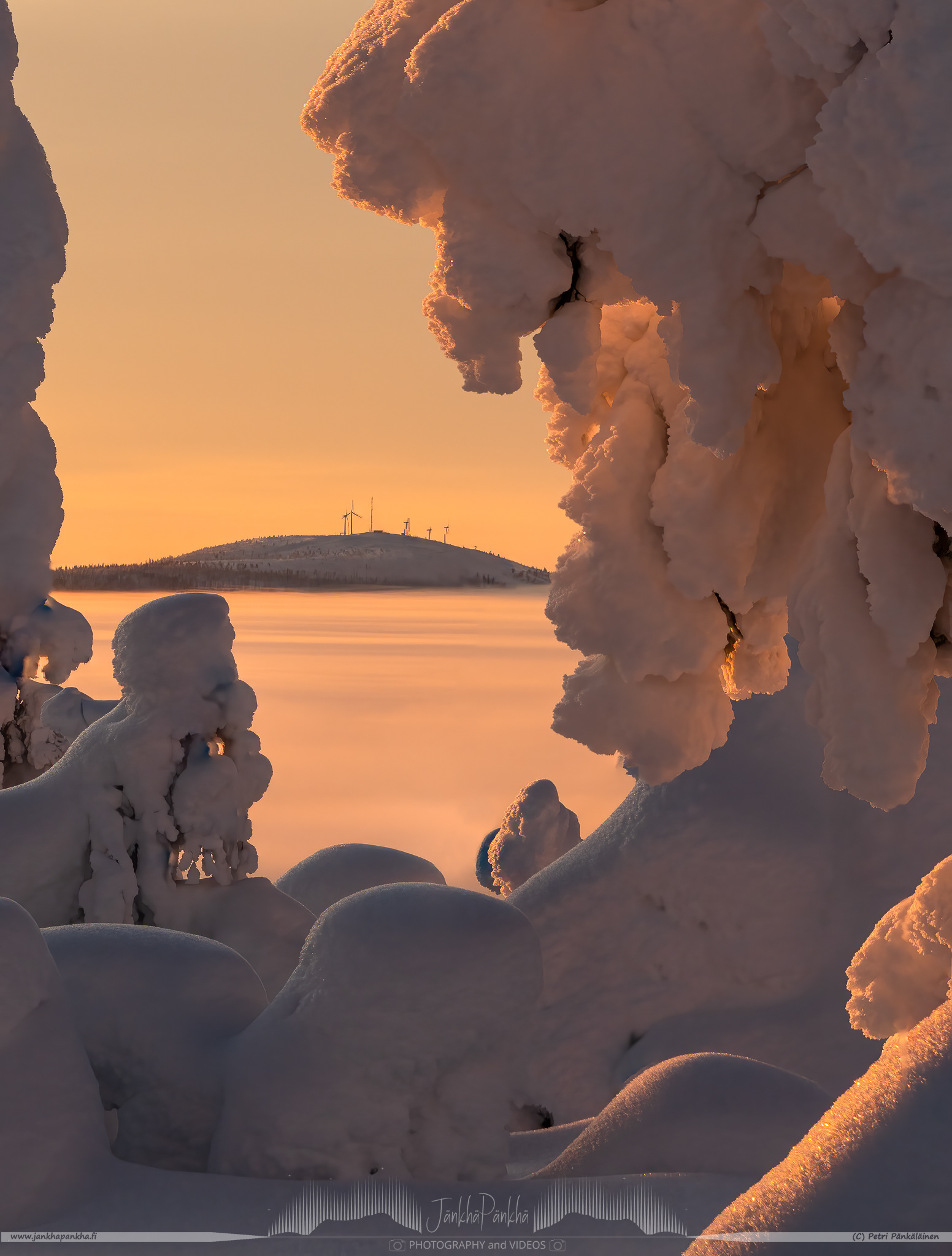 The valley covered with the low hanging clouds nearby the Pallastunturi fell. The Olostunturi fell and Muonio city in the horizon.