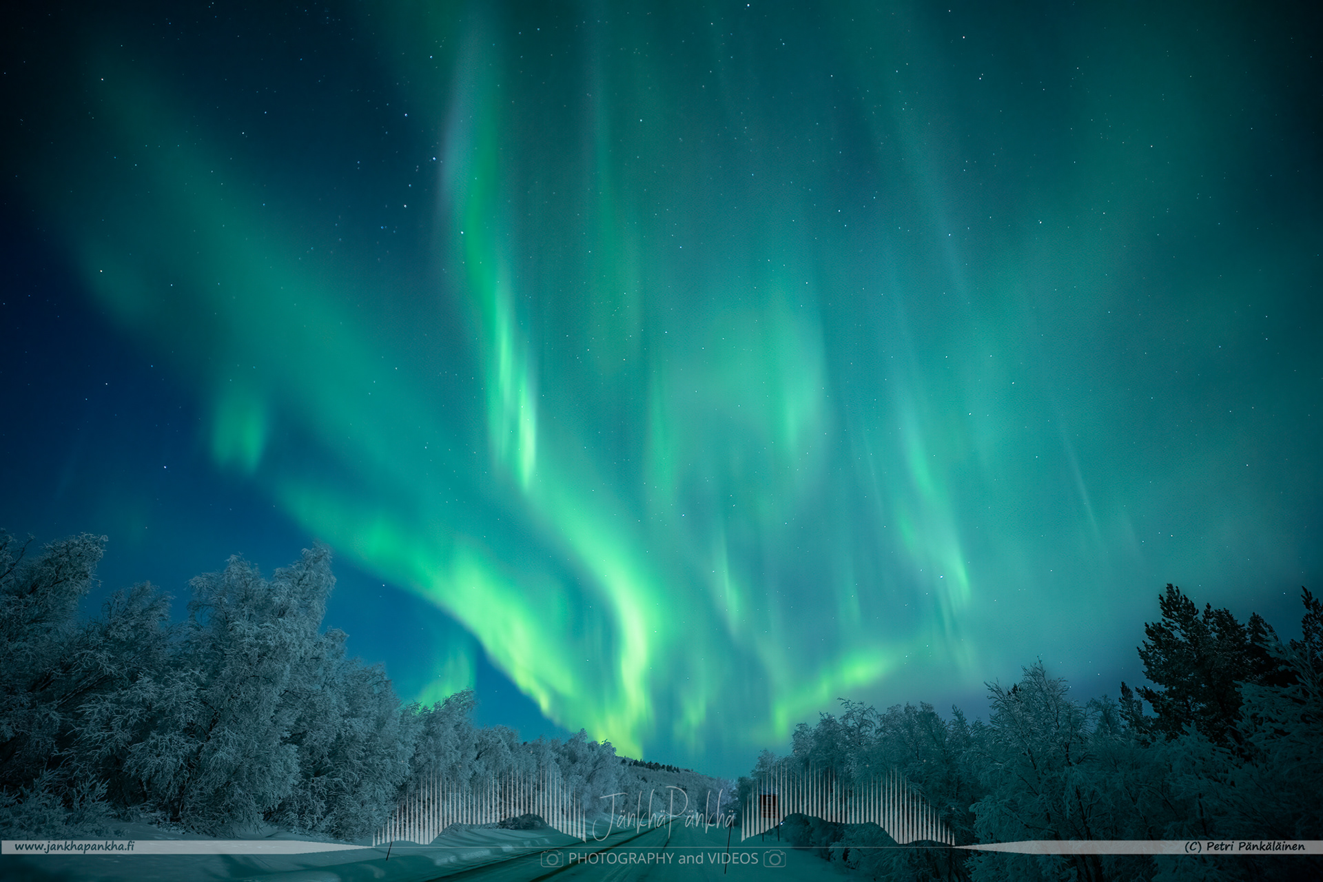 Full sky northern lights over the E4 / E75 road towards Utsjoki in Finland. The full moon eats up the intensity of the northern lights.
