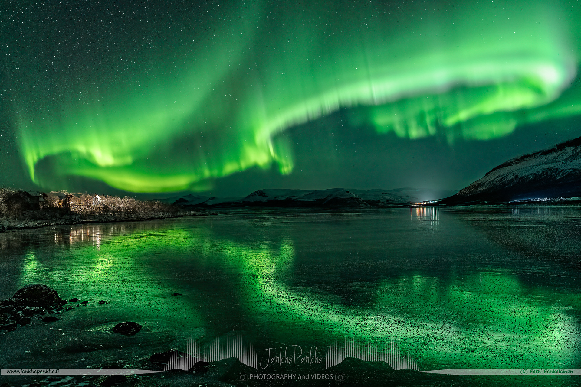 Saanatunturi, fell Saana, in Kilpisjärvi surrounded by the fast moving northern lights and mirror-like ice cover on the lake Kilpisjärvi.