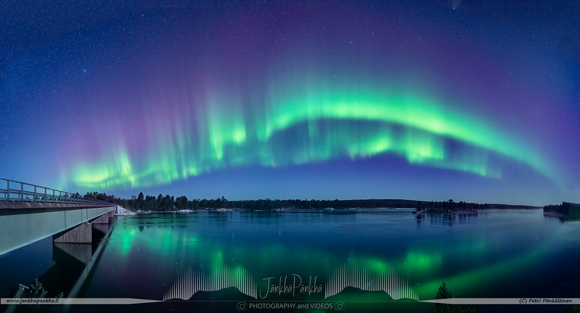 Panorama photo of the northern lights arch nearby the Russian border in Nellim, Finland.