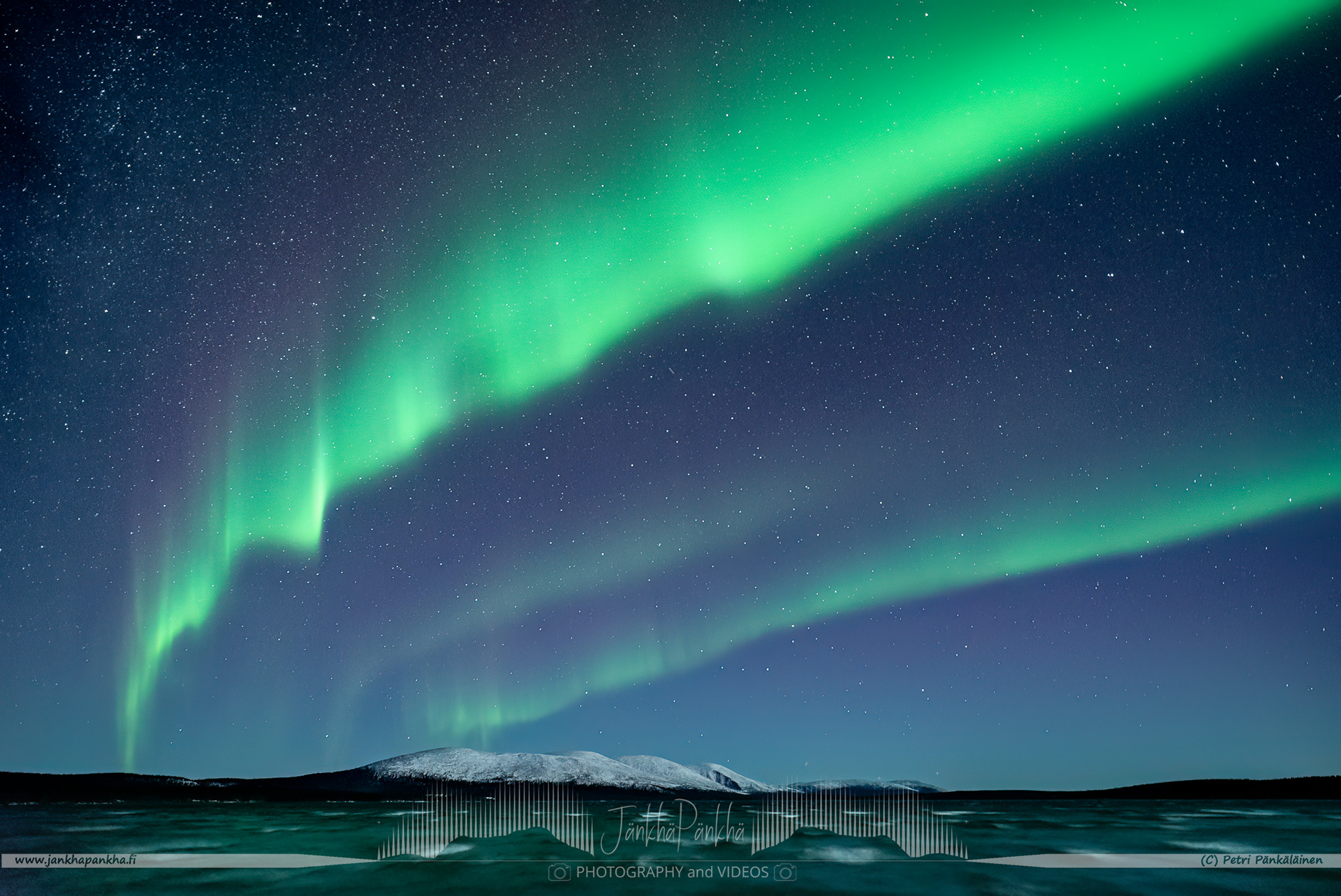 Northern lights over the lake Pallasjärvi nearby Punaisenhiekan autiotupa hut. The photo is from the Punainenhiekka hut. The  Punainenhiekka Day-use Hut is situated at the south end of Lake Pallasjärvi.