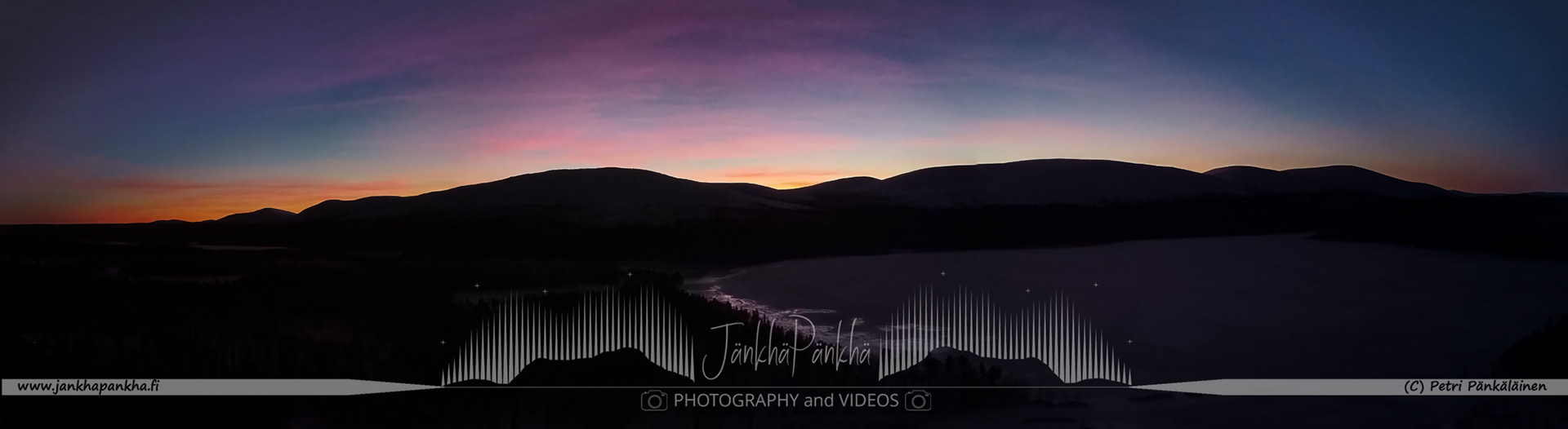 Pastel shades of a winter sunset illuminating the snow-covered fells and candle spruces in Lapland's Pallas-Yllästunturi. The silhouette of the 7 fells' chain of Pallastunturi is beautifully backlight illuminated.