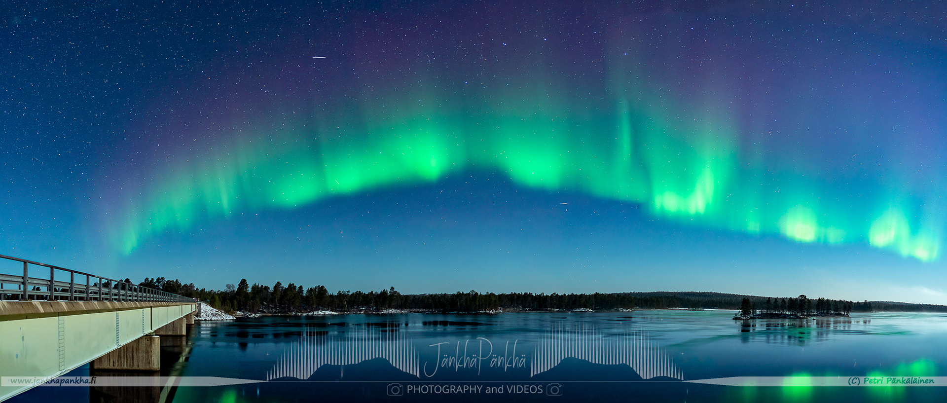 Panorama photo of the northern lights arch nearby the Russian border in Nellim, Finland.