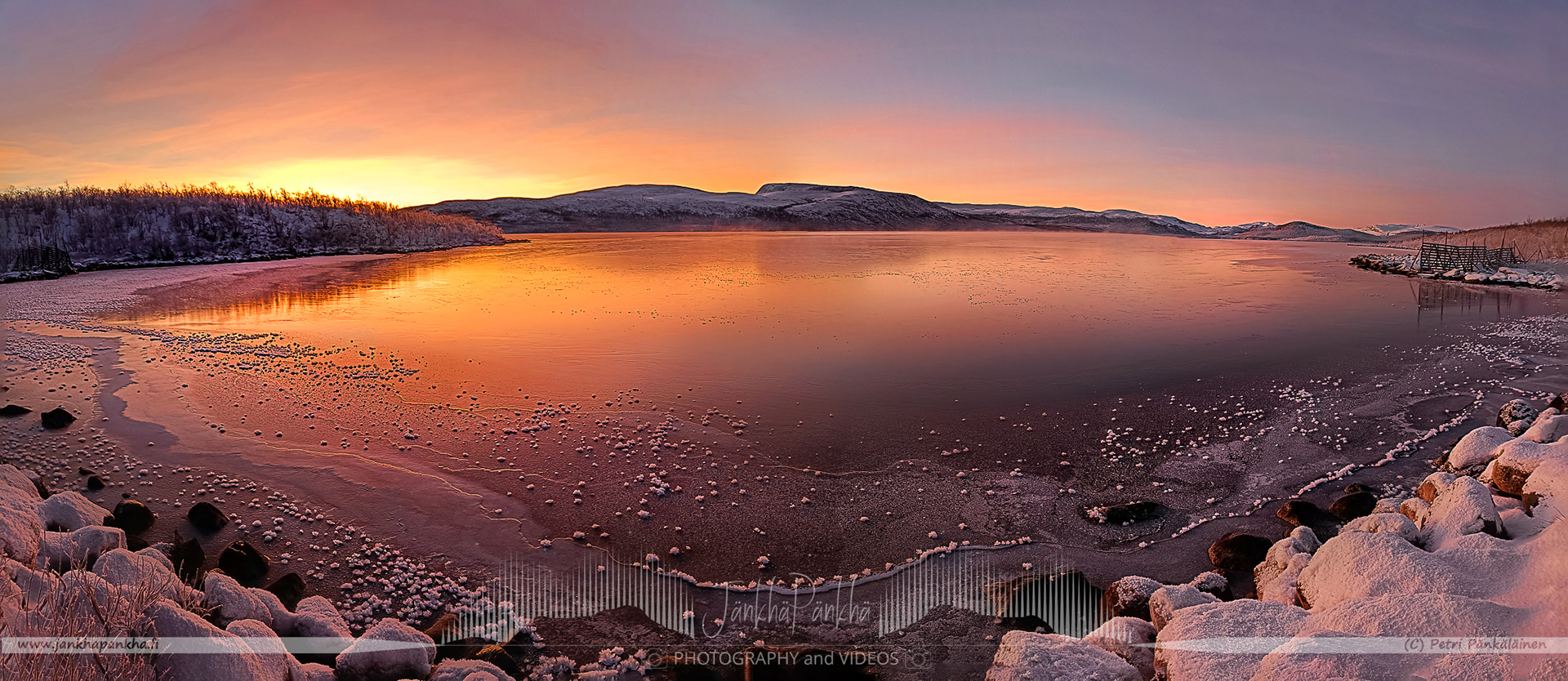 Captivating sunset reflection on the ice of Lake Kilpisjärvi, Enontekiö, with hues of orange and pink."