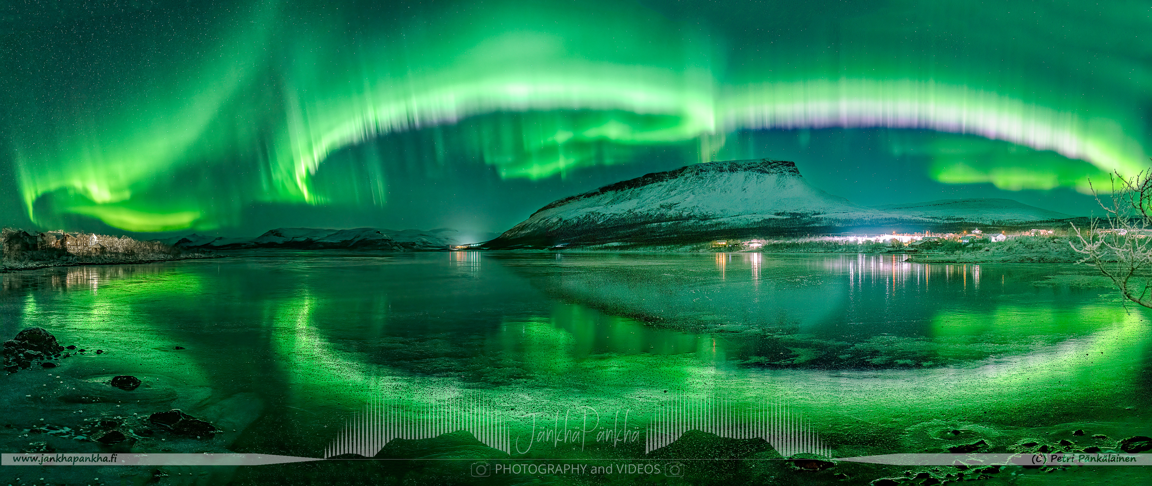 Saanatunturi, fell Saana, in Kilpisjärvi surrounded by the fast moving northern lights and mirror-like ice cover on the lake Kilpisjärvi. This is a not a real panorama "exactly" but a composition of three photos. All photos were taken from the same place within 4 minutes to capture how the show proceeded towards the village of Kilpisjärvi.